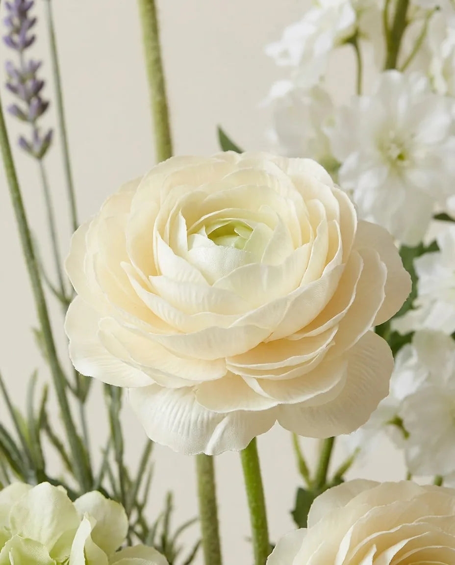 Gros plan sur les renoncules artificielles du bouquet Prairie Blanche