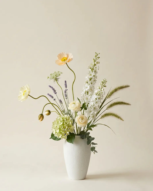 Bouquet artificiel de pavots d'Islande, hortensias et lavande blanc et vert dans un vase en céramique
