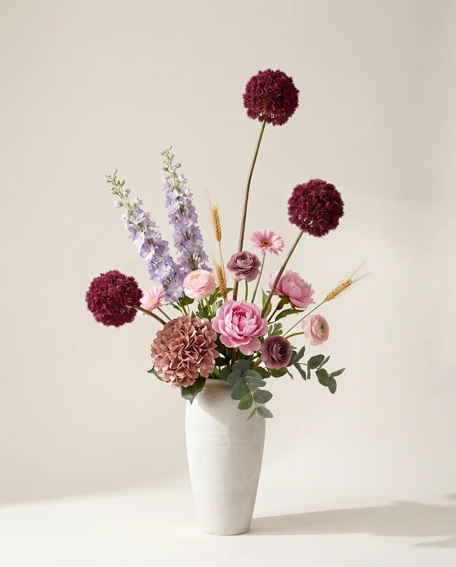 Bouquet artificiel de pivoines, hortensias et alliums rose et violet dans un vase en céramique