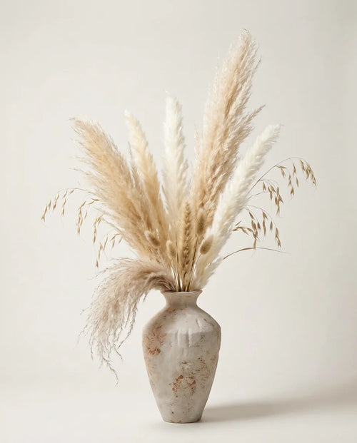 Bouquet de graminées artificielles beige et rose dans un vase en céramique