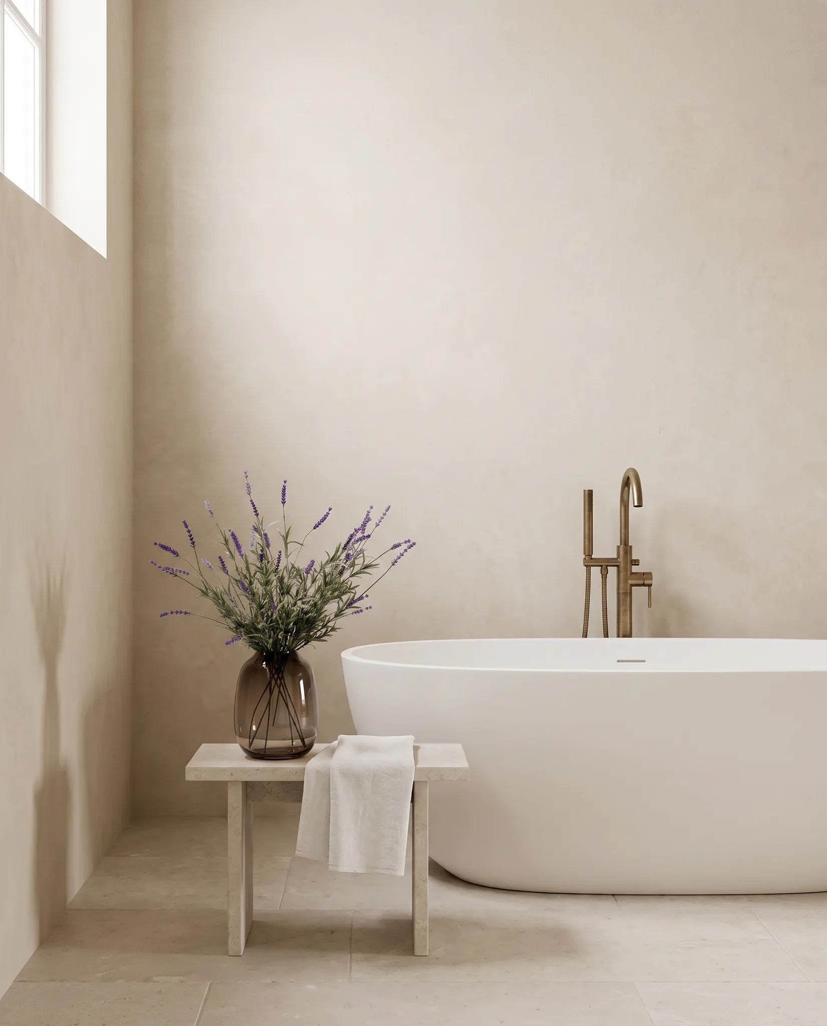 Bouquet artificiel violet sur un tabouret en pierre, salle de bain à la baignoire îlot