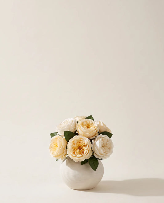 Bouquet artificiel de roses crème dans un vase en céramique