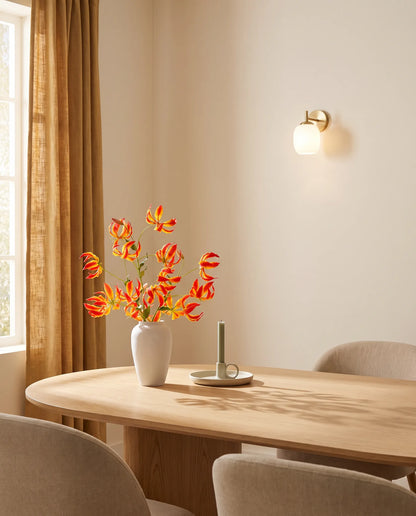 Bouquet artificiel rouge et or sur une table ovale en chêne clair, salle à manger