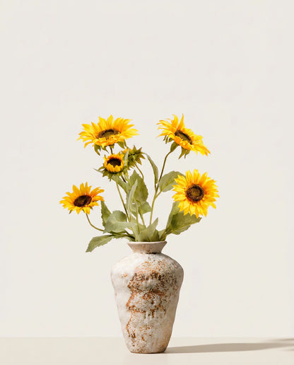 Vase terracotta patiné avec bouquet de tournesols jaunes artificiels